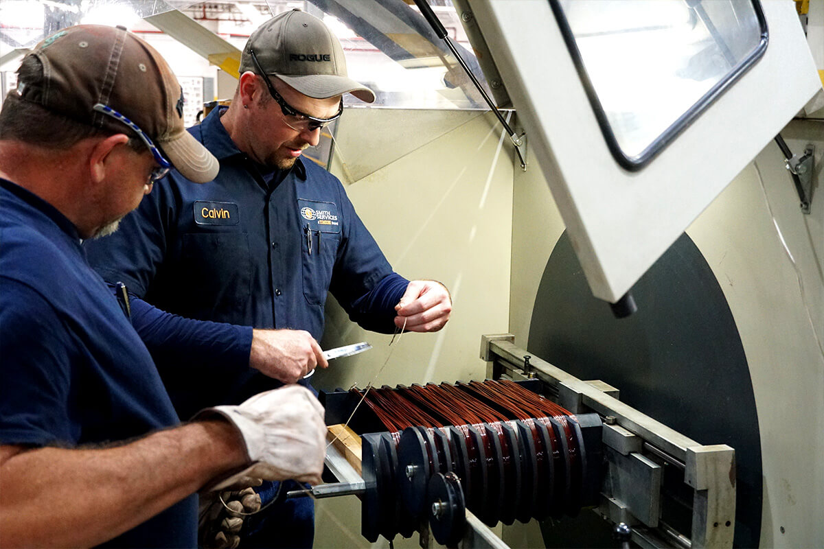 Smith Services staff winding wires on a generator