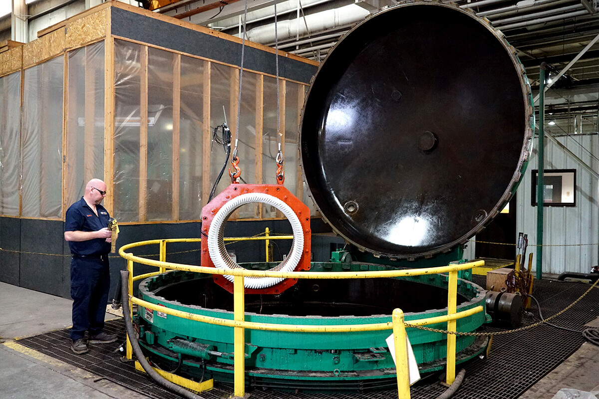Smith Services technician lowering a motor into the VPI tank to improve insulation