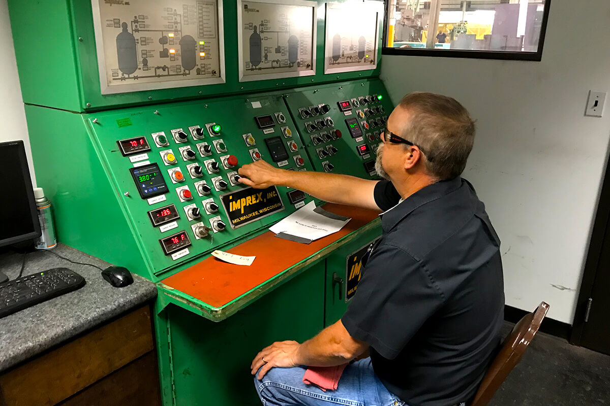 Smith Services engineer testing at a control panel