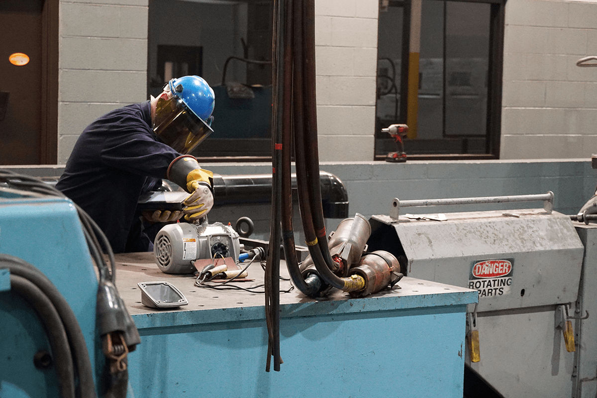 Smith Services technician with an electric motor testing it before completing the full electric motor repair process.